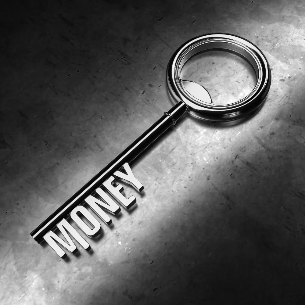 A key labeled "MONEY" is illuminated against a dark background, symbolizing asset protection.