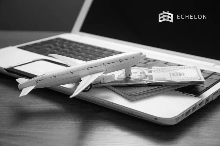 A model airplane rests on a stack of cash and a passport atop a laptop, symbolizing aircraft bonus depreciation, with the Echelon logo in the top right corner.