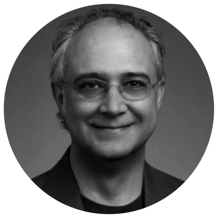 Smiling man with glasses and short gray hair, wearing a dark suit, in a black and white circular-cropped portrait.